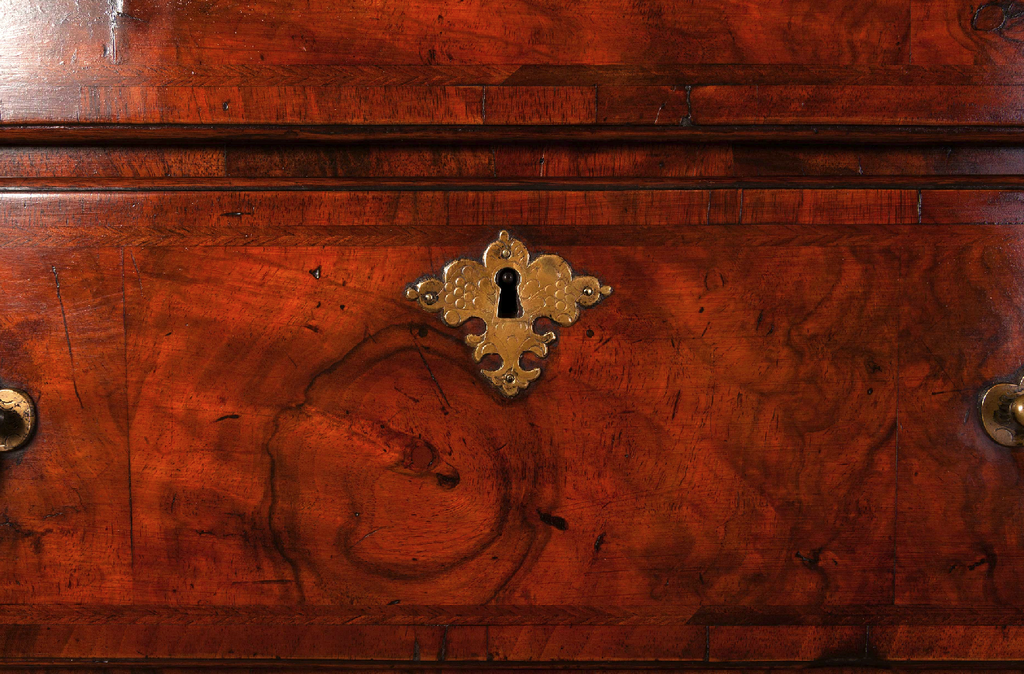detail of a burr walnut antique chest on chest