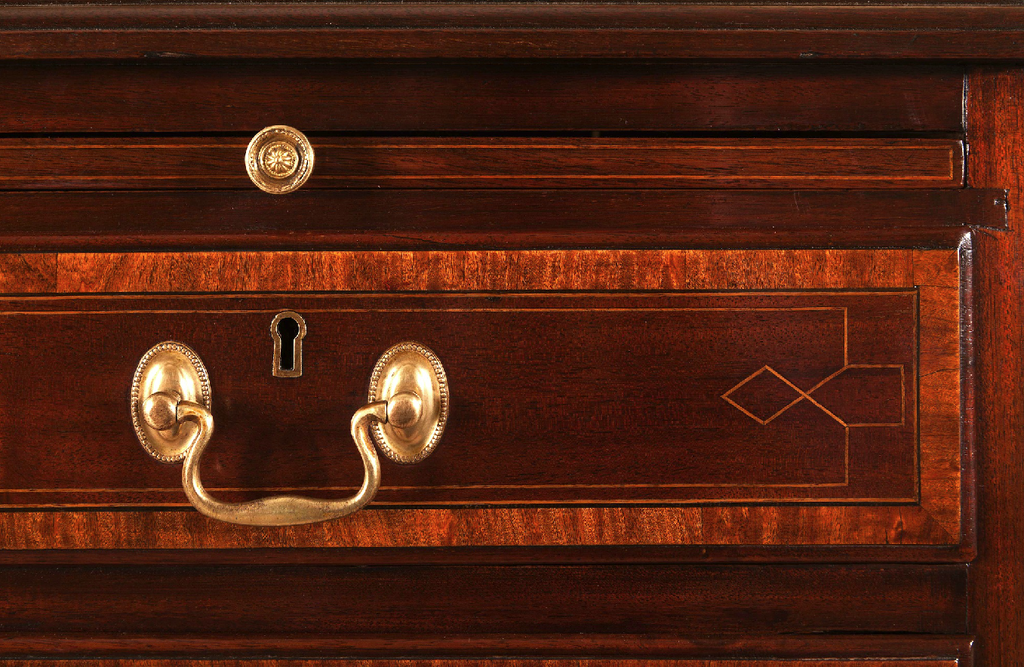 detail of antique mahogany and satinwood chest of drawers